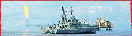 Armadale class patrol boat HMAS Glenelg patrols past oil rigs in the Timor Sea.